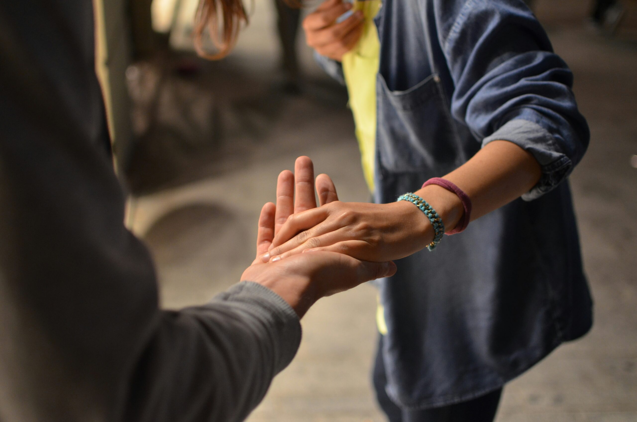 a person holding another's hand